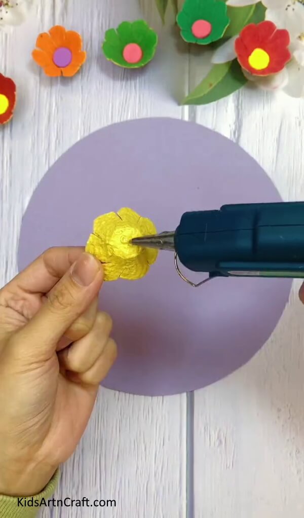 Applying Glue On The Flower - Construct a flower with a pre-used egg carton in the abode. 