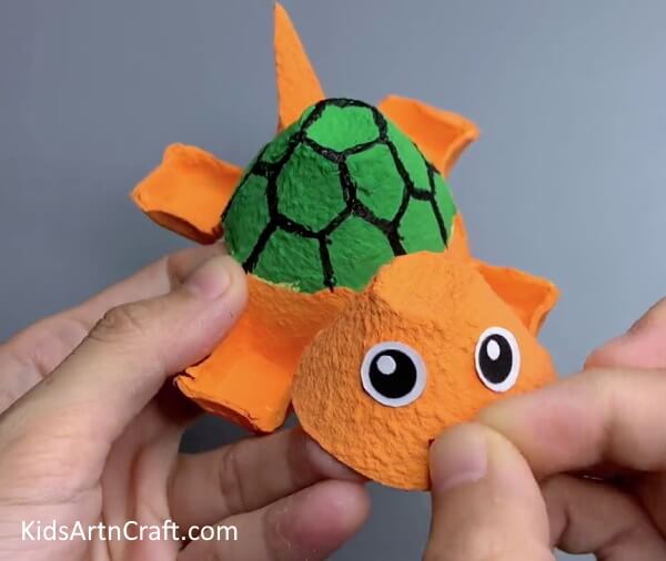 Making Eyes And Mouth Of The Turtle - Construct a Turtle from a Reused Egg Carton with your Children