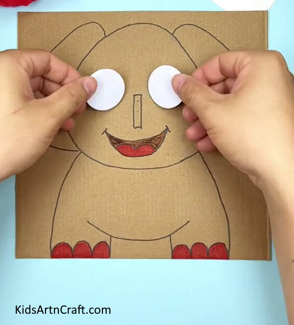 Pasting White Circles To Make Eyes- Create an Elephant Using Cardboard for Kindergartners