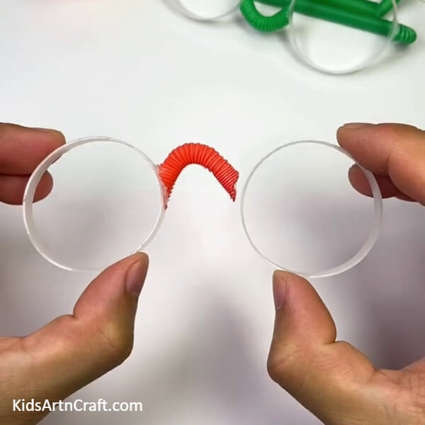 Joining The Frames With The Straw- Master the DIY skill of creating Eye Glasses from a Plastic Bottle and Straw with this tutorial. 