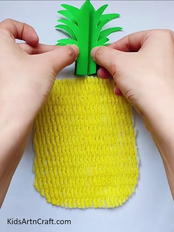 Create a Green Sheet Of Paper And Cut It- Making your own Pineapple Craft using DIY instructions. 