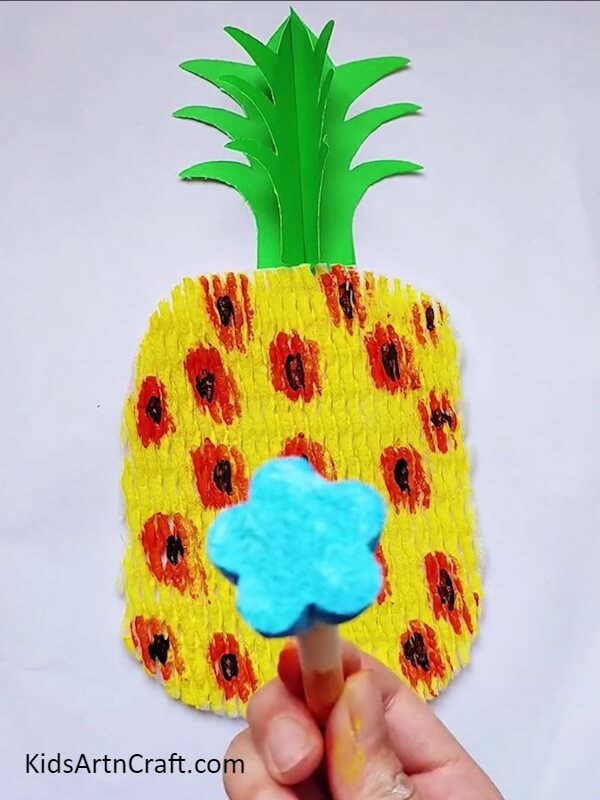 Take Flower Shaped Stamp And Fill It With Blue Colour- Learn how to make a Pineapple Craft yourself with these directions. 