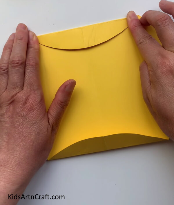 Folding The Sides Of The Circle- Making a Present Bag from Handmade Paper and Handles 