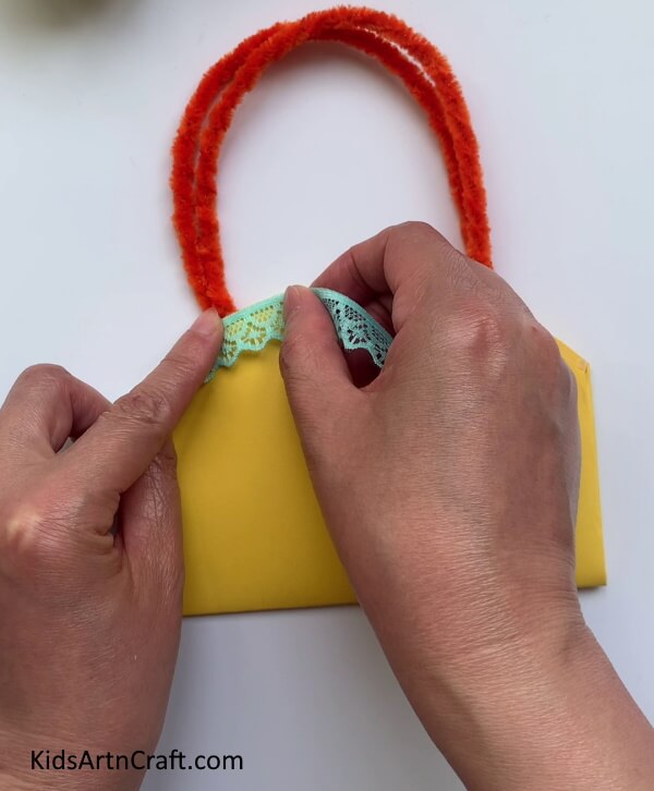 Pasting A Cloth Lace On The Paper Bag- Developing a Gift Bag from Homemade Paper and Handles