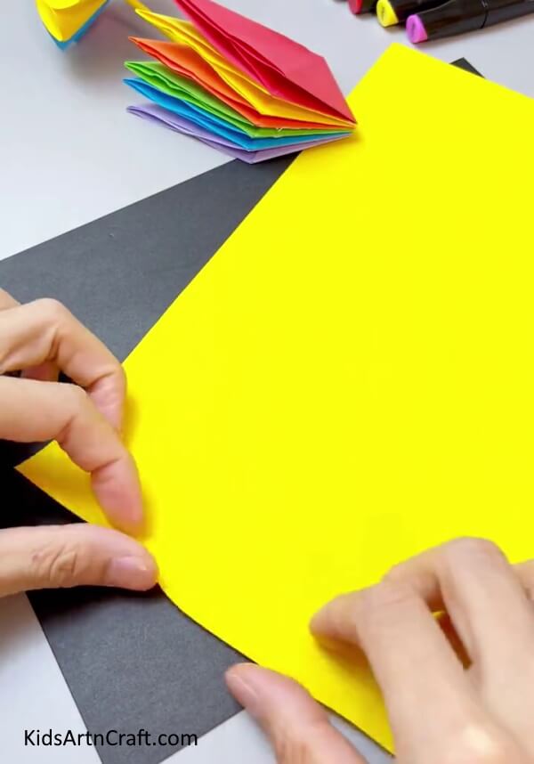 Folding Yellow Paper - Put together a handheld fan with exciting paper for children.