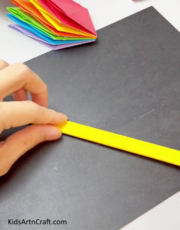 Making Yellow Paper Strip - Crafting a Hand Fan out of Vibrant Paper for Children 