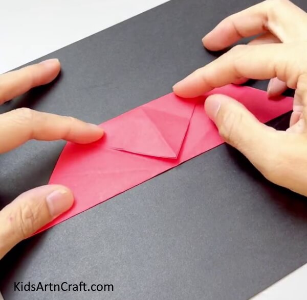 Bringing the Top Corner Downwards - Assemble a fan using colorful paper for kids.