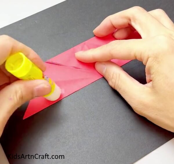 Applying Glue - Construct a hand fan with multi-colored paper for young ones.