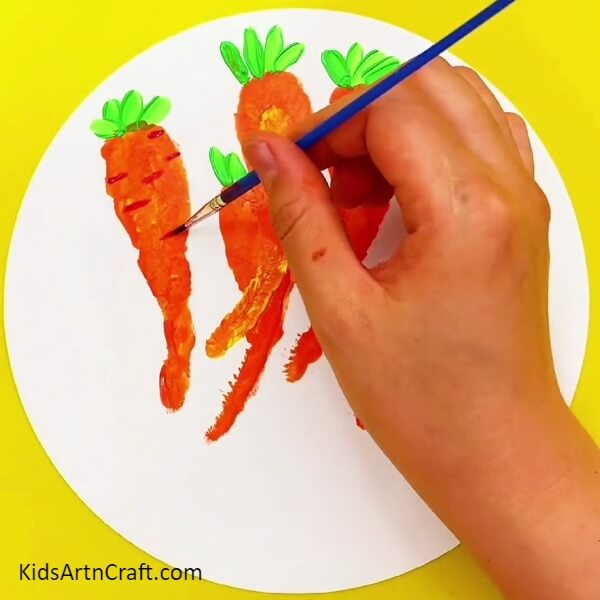 Detailing The Carrots - A fun DIY project for your kids: painting a handprint carrot in a basket.