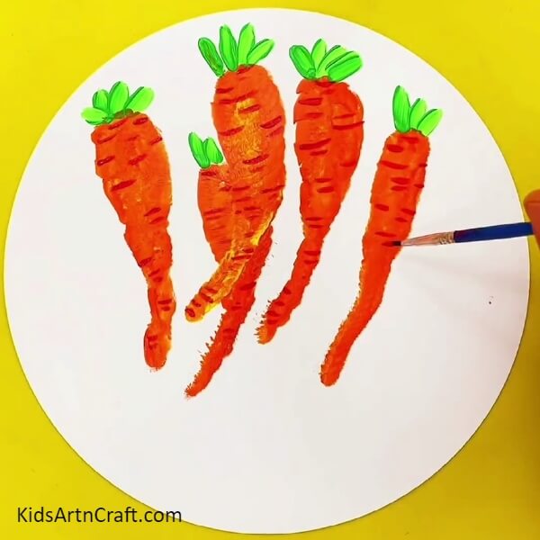 Completing Detailing All The Carrots - Get your children to make a handprint-shaped carrot in a basket painting. 