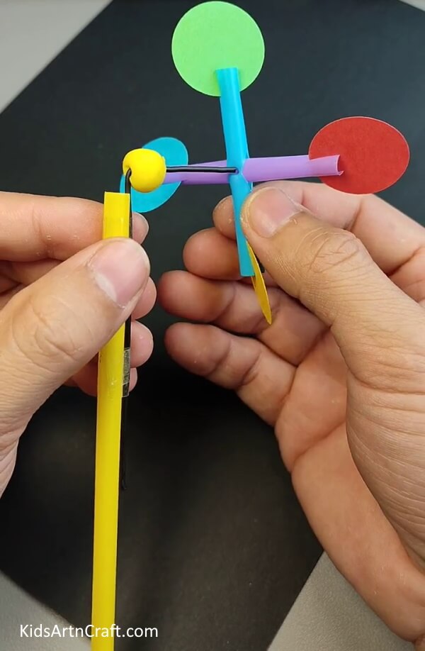 Insert the paper clip in the plus sign through a hole- Self-made Straw Fan - An Easy Tutorial for Little Ones 