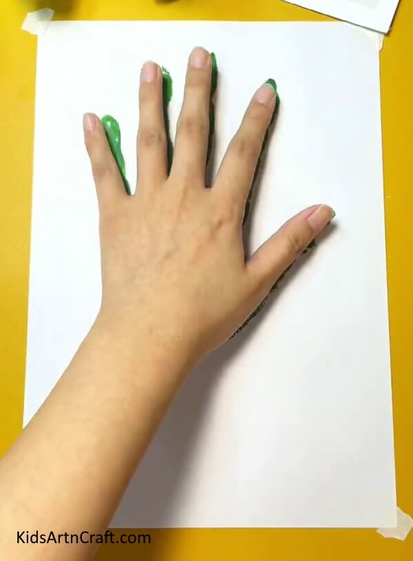 Stamping the Sheet With your Hand- Crafting a Cactus handprint project with kids in the house. 