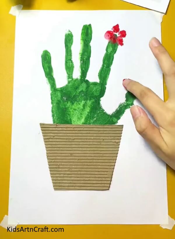 Making a Flower On the Cactus- An easy and fun Cactus handprint artwork activity for kids to do at home. 