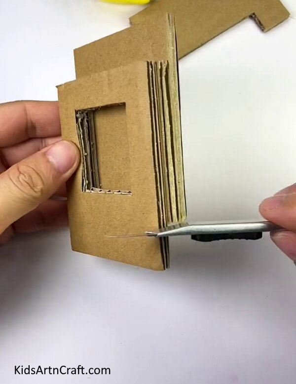Trimming The Left Over Cardboard-A Guide on Manufacturing a Heart Shooter for Young People