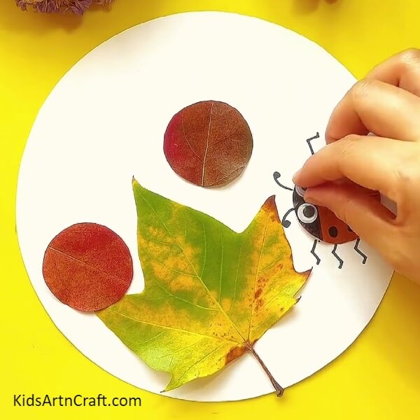 Pasting The Eyes-How to Make a Ladybug Leaf Craft from Scratch