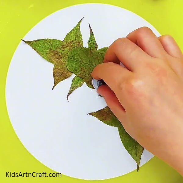 Pasting a pair of googly eyes Tutorial For Creating a Fishy Scene With Leaves For Children 