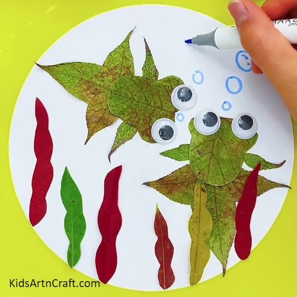 Making some under water bubbles.- Tutorial On How To Make a Fishy Underwater Scenery With Leaves For Kids 