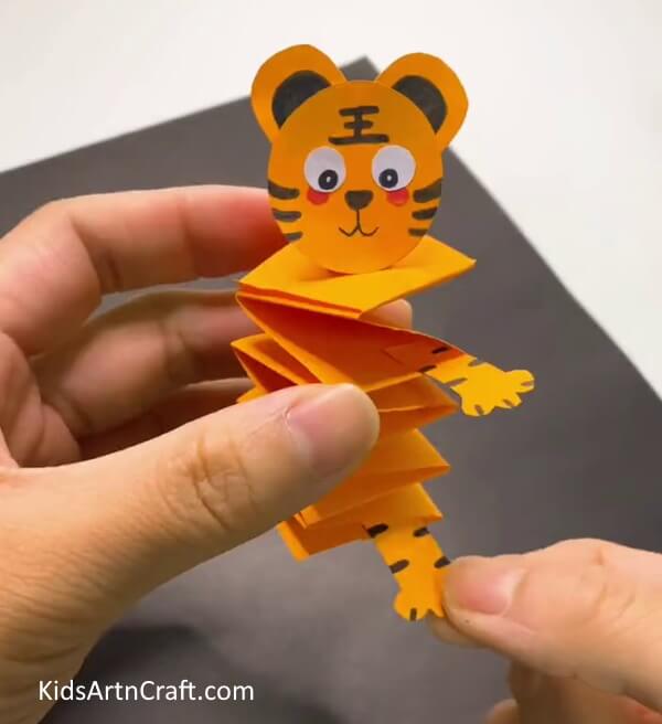 Adding Limbs To The Body-Have fun crafting a moving tiger out of paper with your kids.