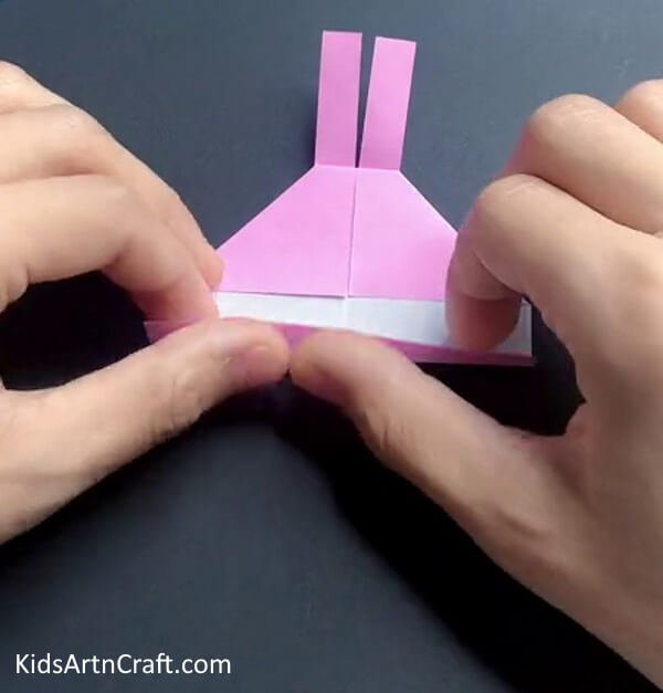 Folding The Side To the Triangle's End-Producing a Bunny Ring out of Origami for Kids