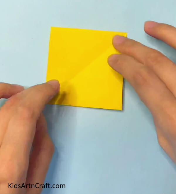 Begin with a square shape craft paper A Simple Guide to Making an Origami Paper Crown for Children