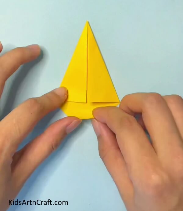 Now fold it into a triangle- Step-by-Step Guide to Crafting an Origami Paper Crown for Kids