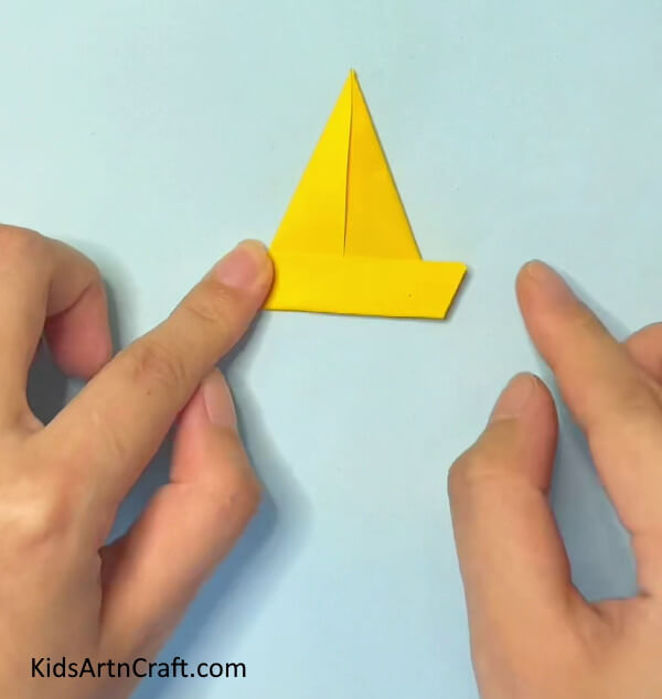 Fold the rest of the paper inwards- Teach Your Kids How to Make an Origami Paper Crown