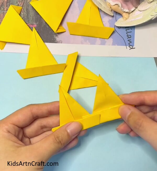Attach each Pieces together- Instructions for Crafting an Origami Paper Crown for Children