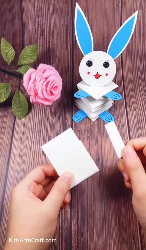 Gluing The Ends Together After The Spring Like Structure Is Formed-Home-Crafted Paper Bunny for Easter Decor