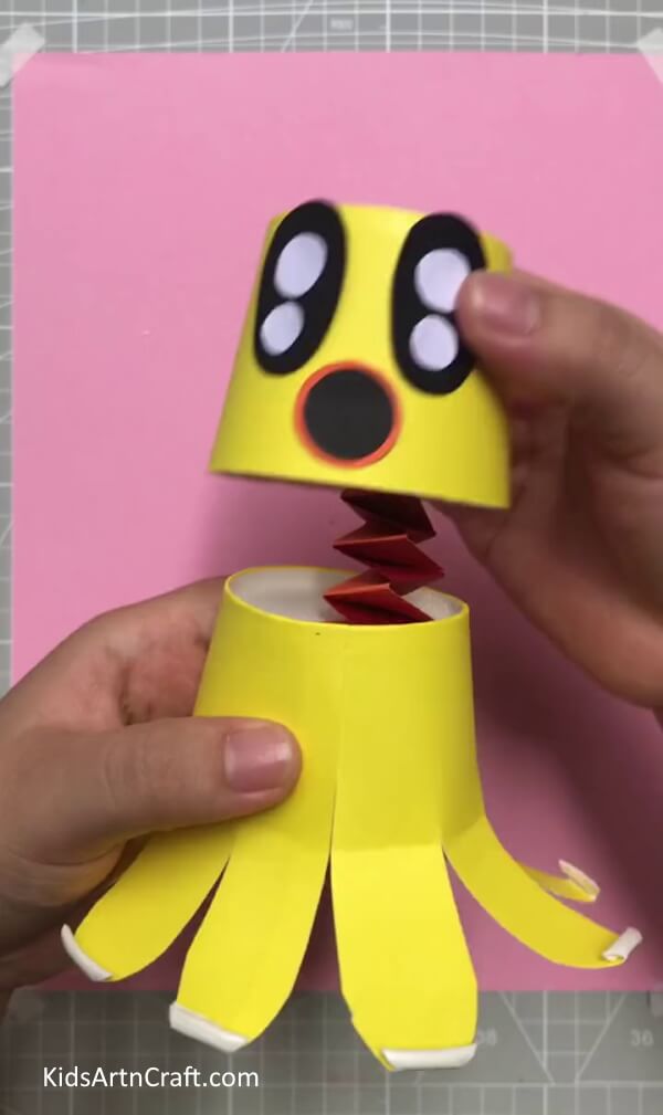 Pasting Face To The Strip - Step-by-Step Guide for Making a Paper Cup Octopus for Kids 