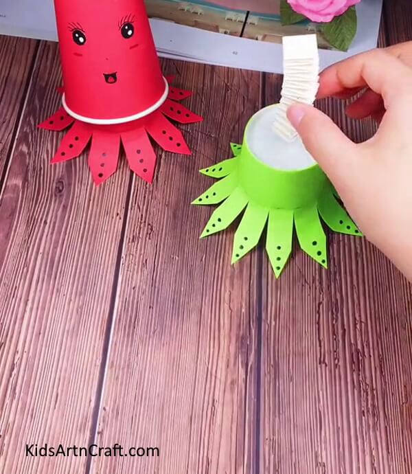 Sticking The Spring Atop The Octopus Legs Cup-DIY Paper Cup Octopus - A Guide for Kids 