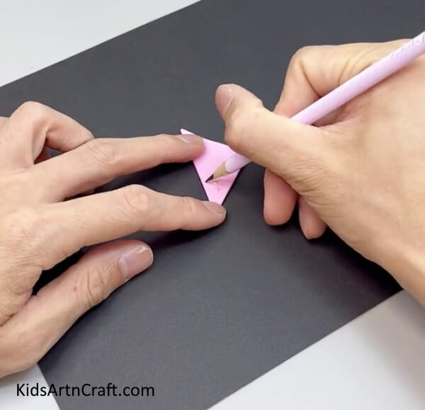 Folding The Paper In Triangle And Drawing The Flower - Step-by-step instructions for a Paper Flower Ring project for children
