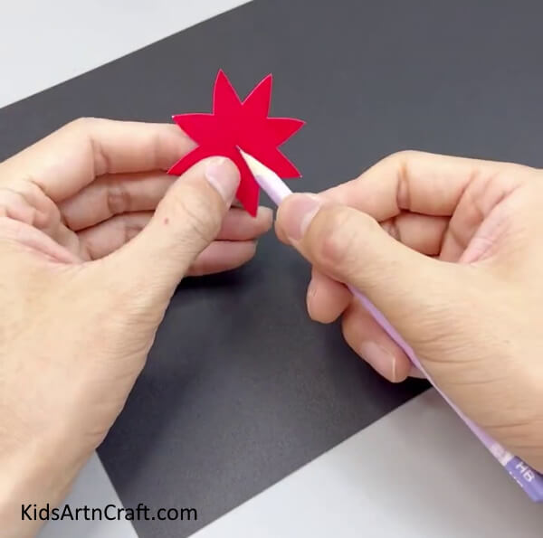 Making Hole In Red Flower - Guide to crafting a Paper Flower Ring for children