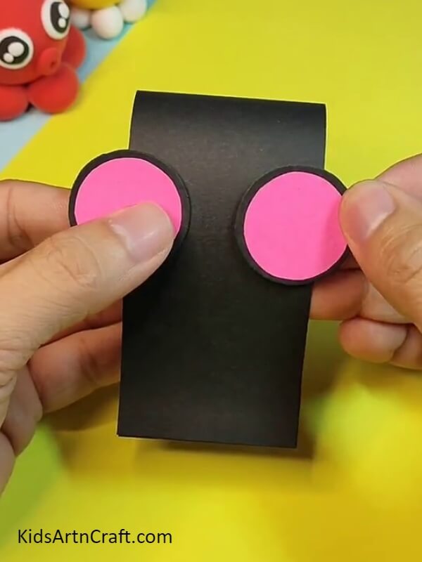 Pasting two circles on this strip- Assemble a Paper Mouse Craft with the assistance of kids