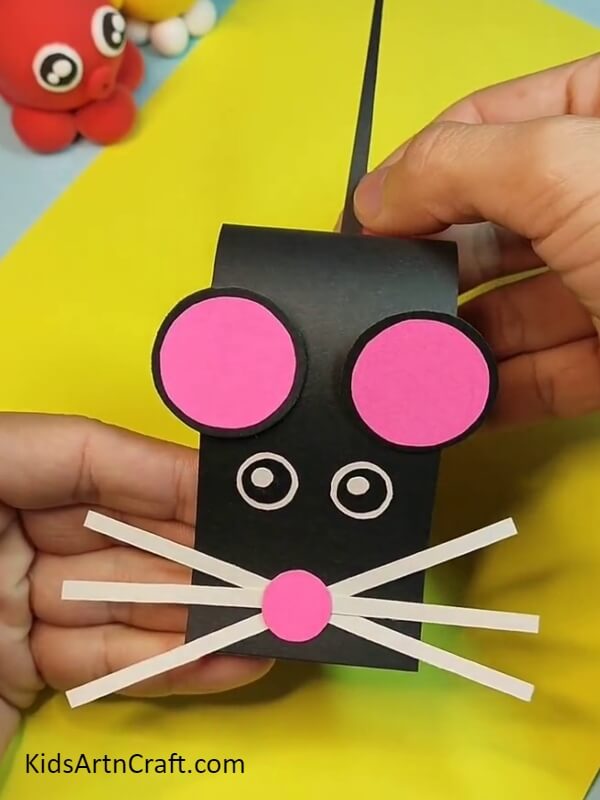 Pasting the tail to the body- Get the children to put together a Paper Mouse project 