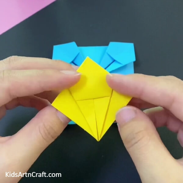 Make A Pattern By Folding The Yellow Square- A Guide On How To Make A Paper Origami Basket For Children