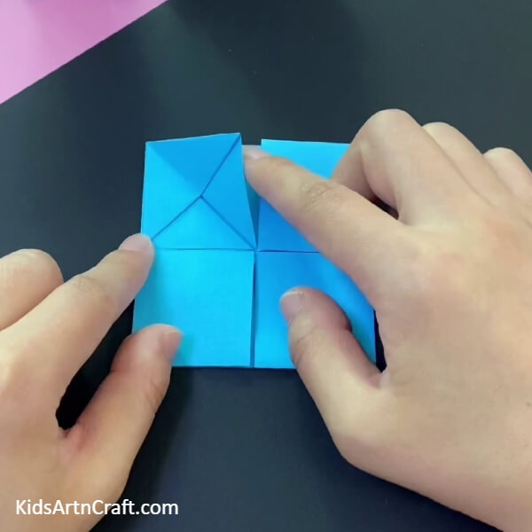 Fold The Upper Square Into Half-With this guide, kids can have fun crafting their own paper origami basket