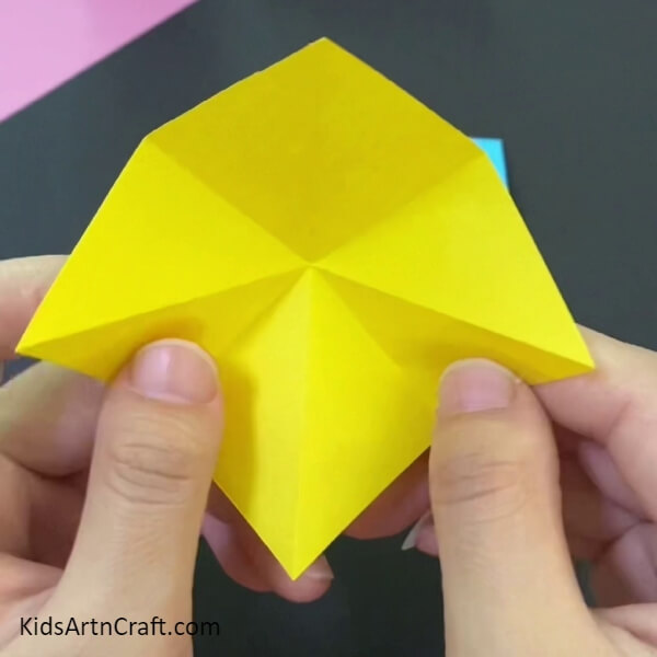 Take A Yellow Sheet And Make Creases-Making a paper origami basket is easy with this tutorial for kids