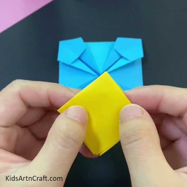 Fold The Square Inside With The Help Of Creases-Kids can create a paper origami basket with this simple step-by-step tutorial