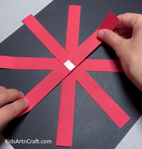 Pasting Every Strips From Red Paper- Step-by-Step Guide to Creating a Paper Strips Flower
