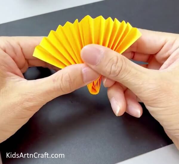 Pasting The Strips In Half - Create Sunflower Art from Paper with Kids