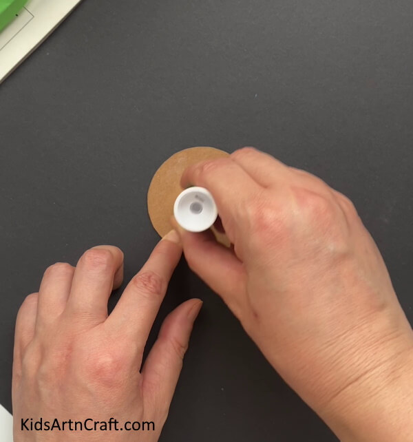 Applying Glue On The Brown Circle -Creating Sunflowers Out Of Paper: A Fun Project For Kids To Try 