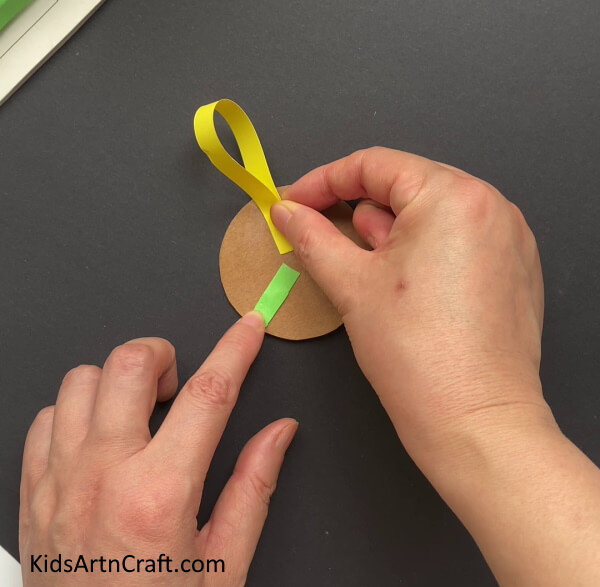 Pasting The Folded Yellow Strip -Sunflower Paper Craft: A Simple Assignment For Kids 