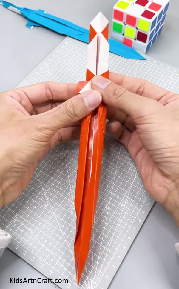 Folding The Paper Sword Model In Half - Crafting a Paper Sword for Kids: Step-by-Step Tutorial