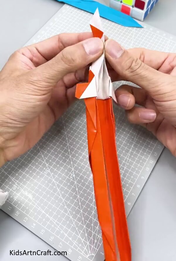 Folding The Hilt Of The Sword In Half - Learn How to Make a Paper Sword with Kids Using This Tutorial