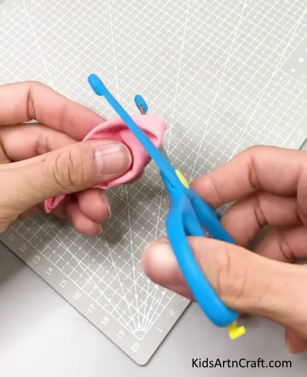 Cutting The Top Of The Balloon - Learn how to make a celebratory party popper with these directions