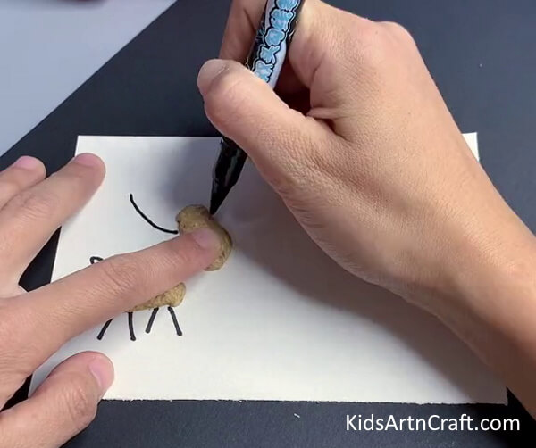 Drawing The Reindeer - Form a Reindeer with peanut shells for the young ones.