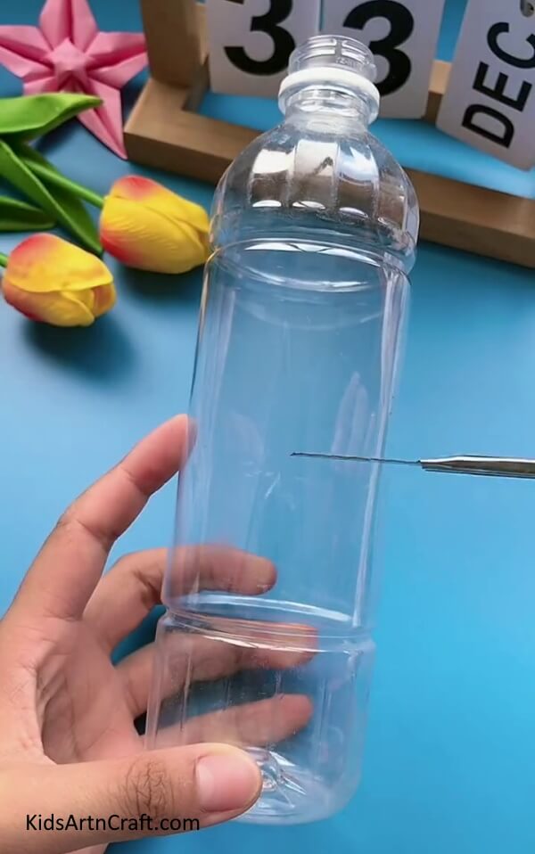 Cutting Plastic Bottle In Half-Create your own pencil holder using plastic bottles and pipe cleaners.