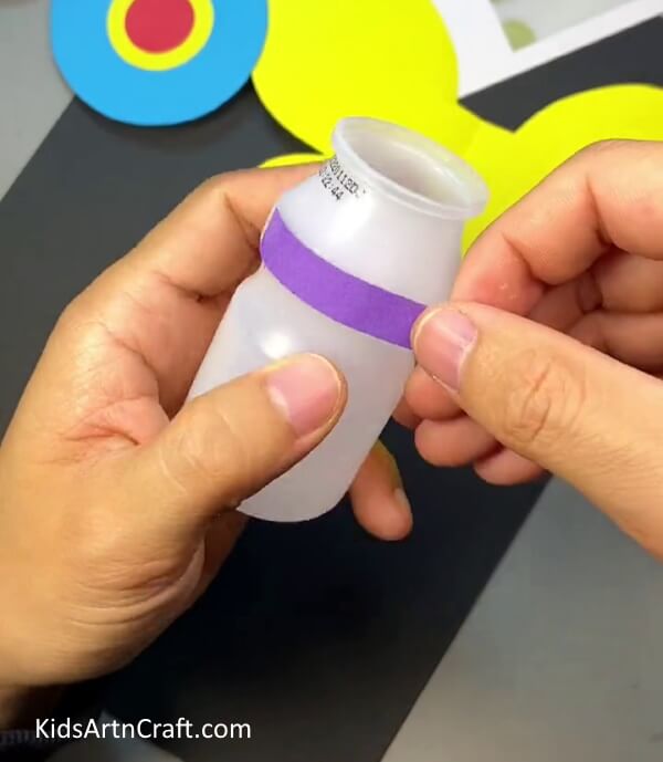Pasting Piece of Violet Color Paper. DIY Plastic Bottle and Paper Bee Craft for kids
