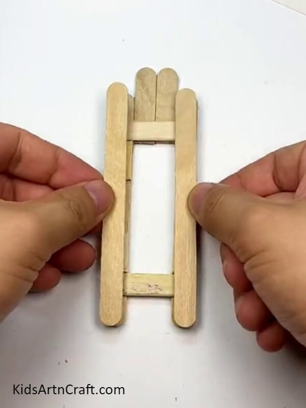 Placing the other two intact sticks - An Instructional Manual for Producing Toys with Popsicle Sticks
