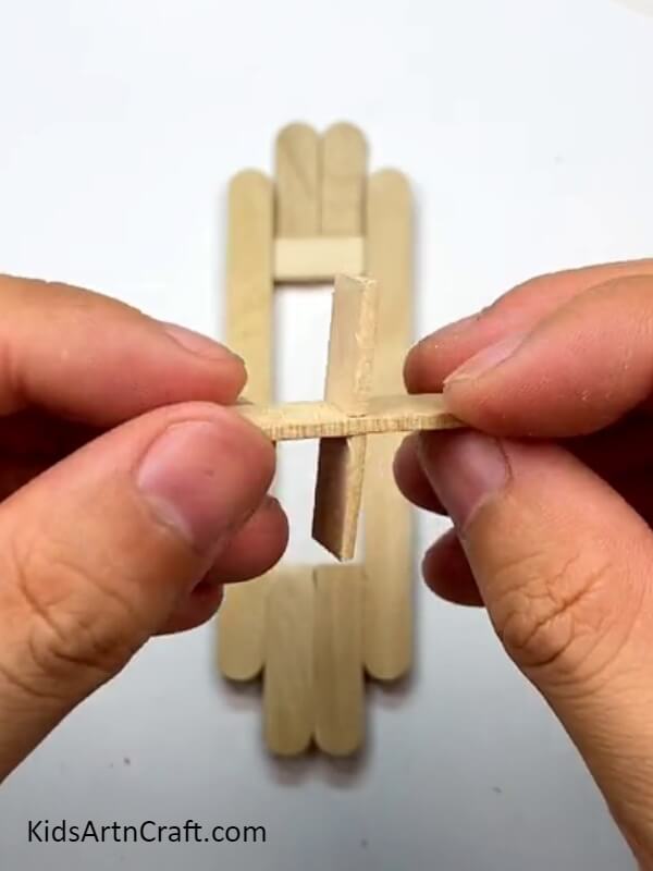 Locking the final two pieces together - A Tutorial for Constructing Toys with Popsicle Sticks for Learners